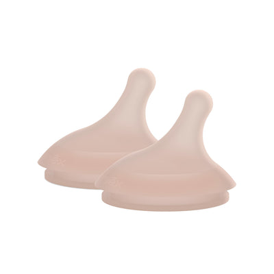 Two pink silicone sippy cup lids on a white background