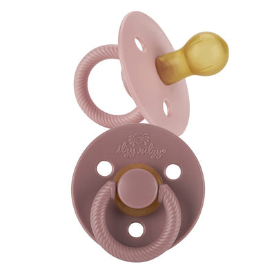 Pink and gold pacifier on a white background