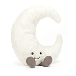Plush toy shaped like a crescent moon with a smiling face on a white background