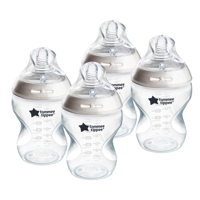 Set of four Tommee Tippee baby bottles on a white background