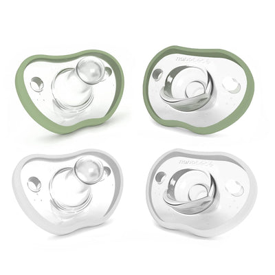 Four baby pacifiers with green and clear design on a white background