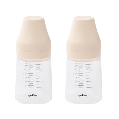 Two Spectra breast pumps with beige caps on a white background