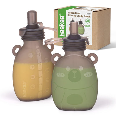 Two silicone goody pouches with a bear design, one green and one brown, next to a cardboard box labeled 'haakaa'.