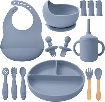 Collection of blue baby feeding utensils including a bib, bowl, cup, and various tools on a white background.