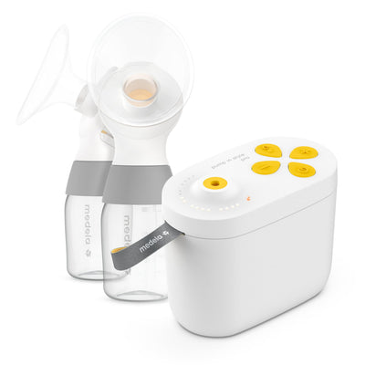 White breast pump with clear bottles on a white background