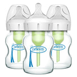 Three Dr. Brown's baby bottles with green nipples on a white background