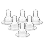 Set of six clear baby bottle nipples on a white background