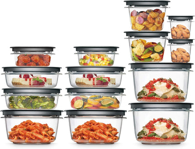 Set of glass food storage containers with various food items inside on a white background